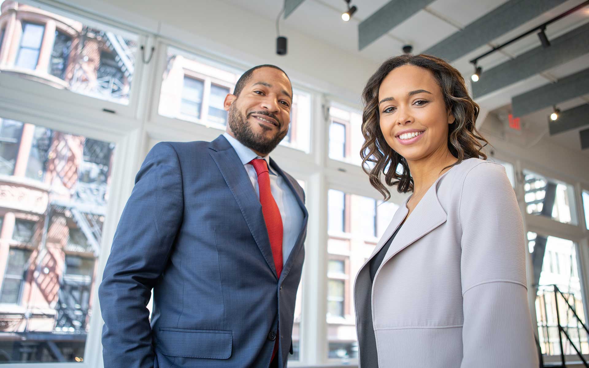 A Black couple in suits represents professional development within the vet training sector.