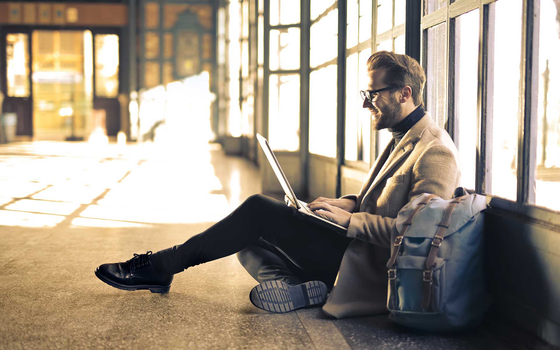 A man works on a laptop, representing flexible vet training options.
