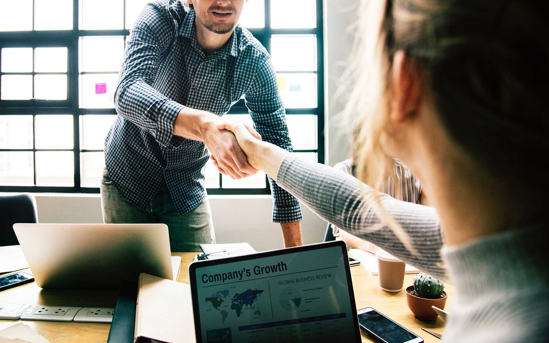 A handshake during a business meeting symbolizes growth and successful rto compliance.