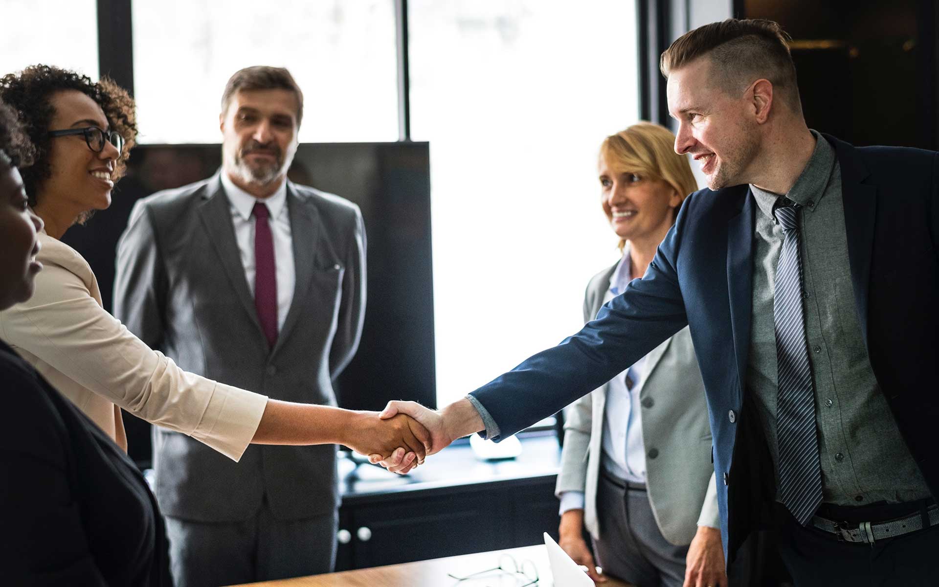 A handshake seals a deal between business professionals, demonstrating successful RTO compliance consulting.