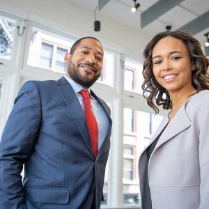 Two business professionals collaborate in an office, demonstrating effective RTO teamwork.