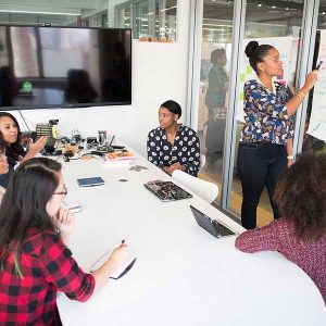 A team discusses strategy during a business meeting, highlighting effective RTO compliance.
