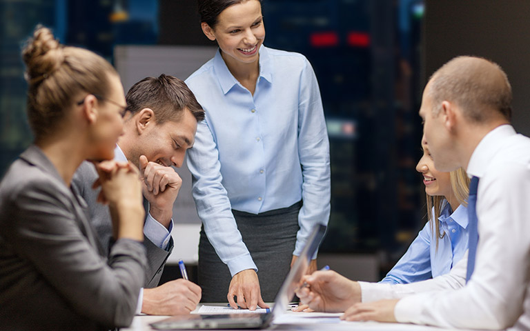 A business team collaborates, demonstrating effective project management for RTO compliance.