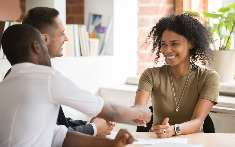 A business meeting shows a handshake during a TAFE transition to a new training package.